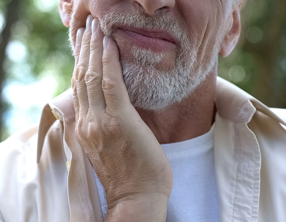 Senior man having problem with teeth, social program of dental p